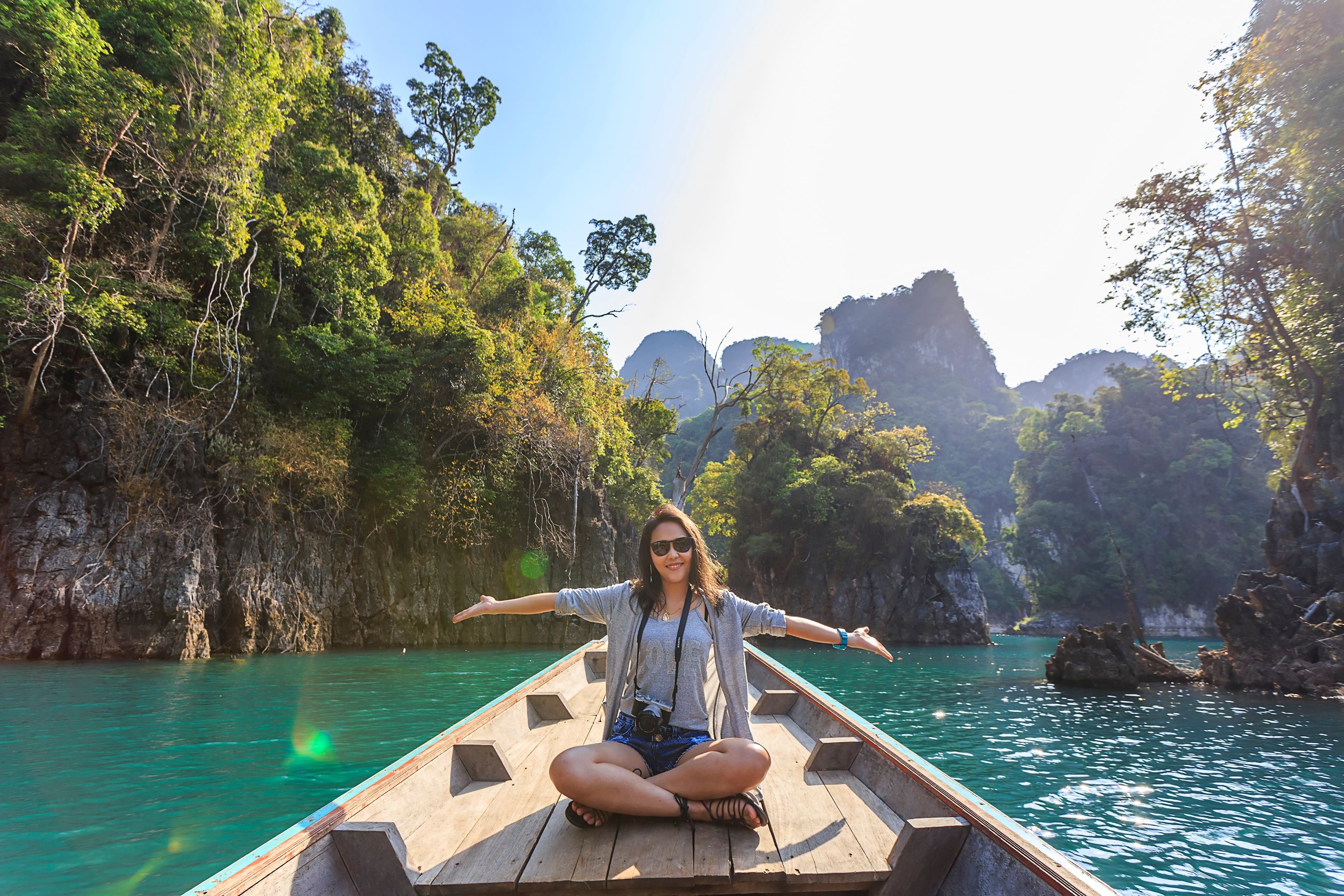 Young woman riding on a boat in a river